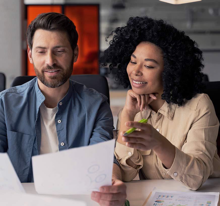 A man and a woman looks into a business plan for a loan